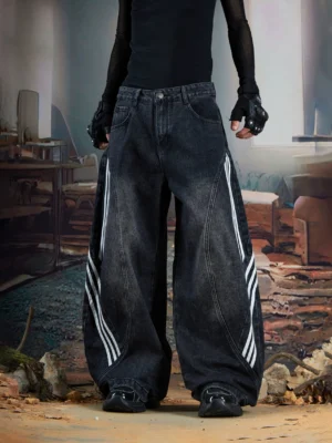 Front view of washed black ultra-baggy wide-leg denim jeans with triple white stripe detailing and curved panel seams for Y2K streetwear