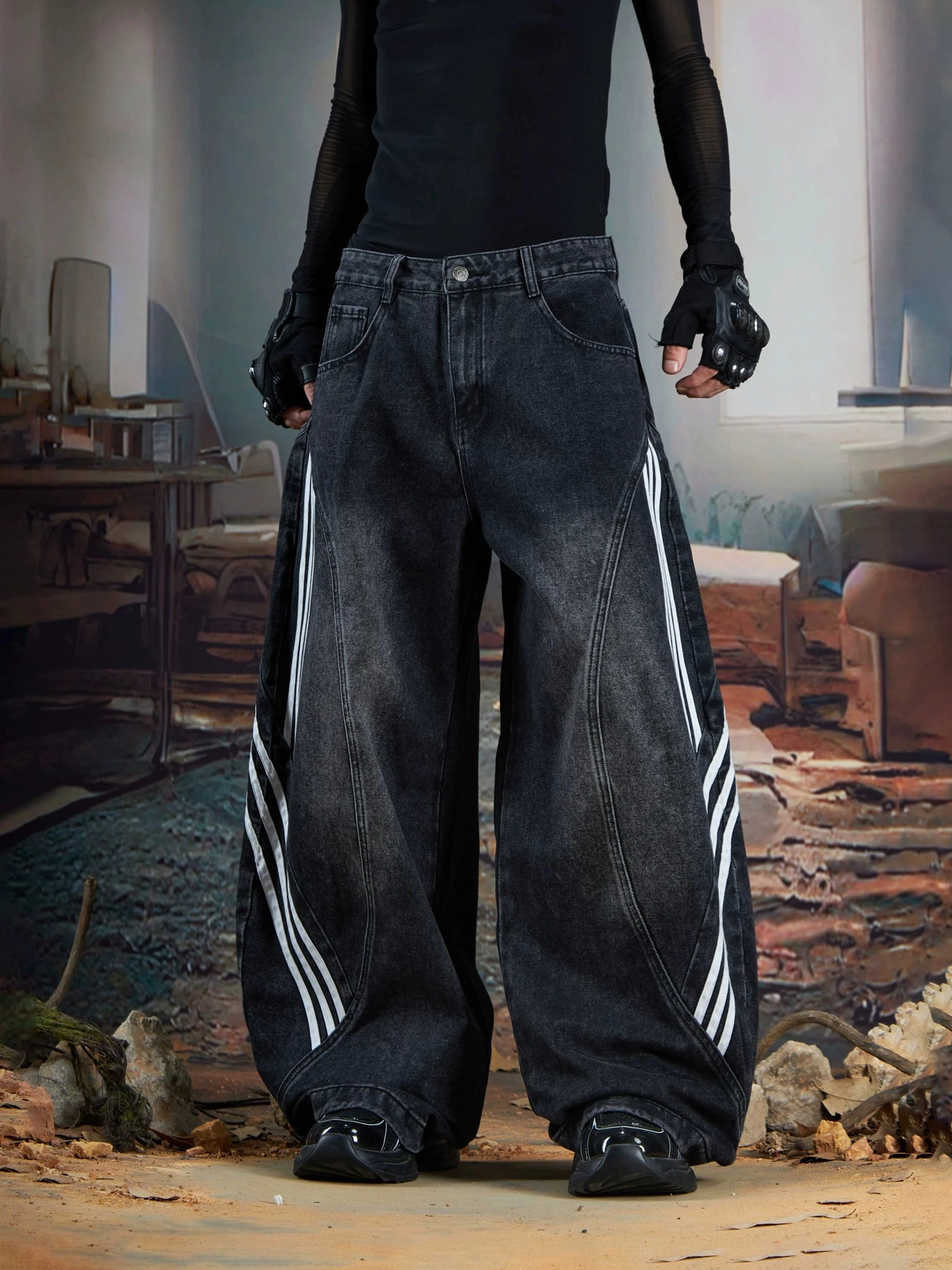Front view of washed black ultra-baggy wide-leg denim jeans with triple white stripe detailing and curved panel seams for Y2K streetwear