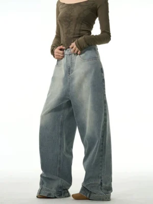 Front full-body view of women’s washed blue inside-out wide-leg jeans with high waist, faded denim panels, layered hems, and relaxed streetwear silhouette