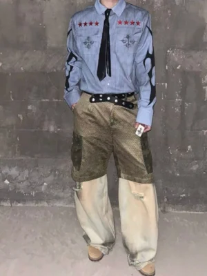 Front view of a washed blue pinstripe button-up work shirt with red star chest details, dual flap pockets, black tribal-inspired sleeve graphics, and oversized streetwear styling