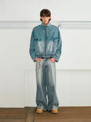 Full-body streetwear outfit featuring light blue wide-leg denim jeans with a matching faded denim jacket and tan loafers