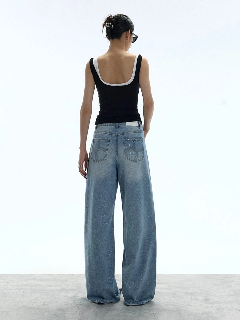 Back view of washed blue wide-leg jeans showing the relaxed fit and classic five-pocket denim construction