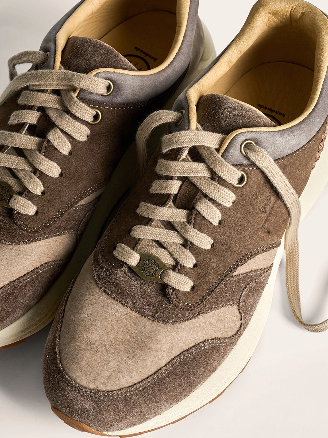 Pair of washed brown retro trail runner sneakers with dual tone suede uppers and soft leather interiors