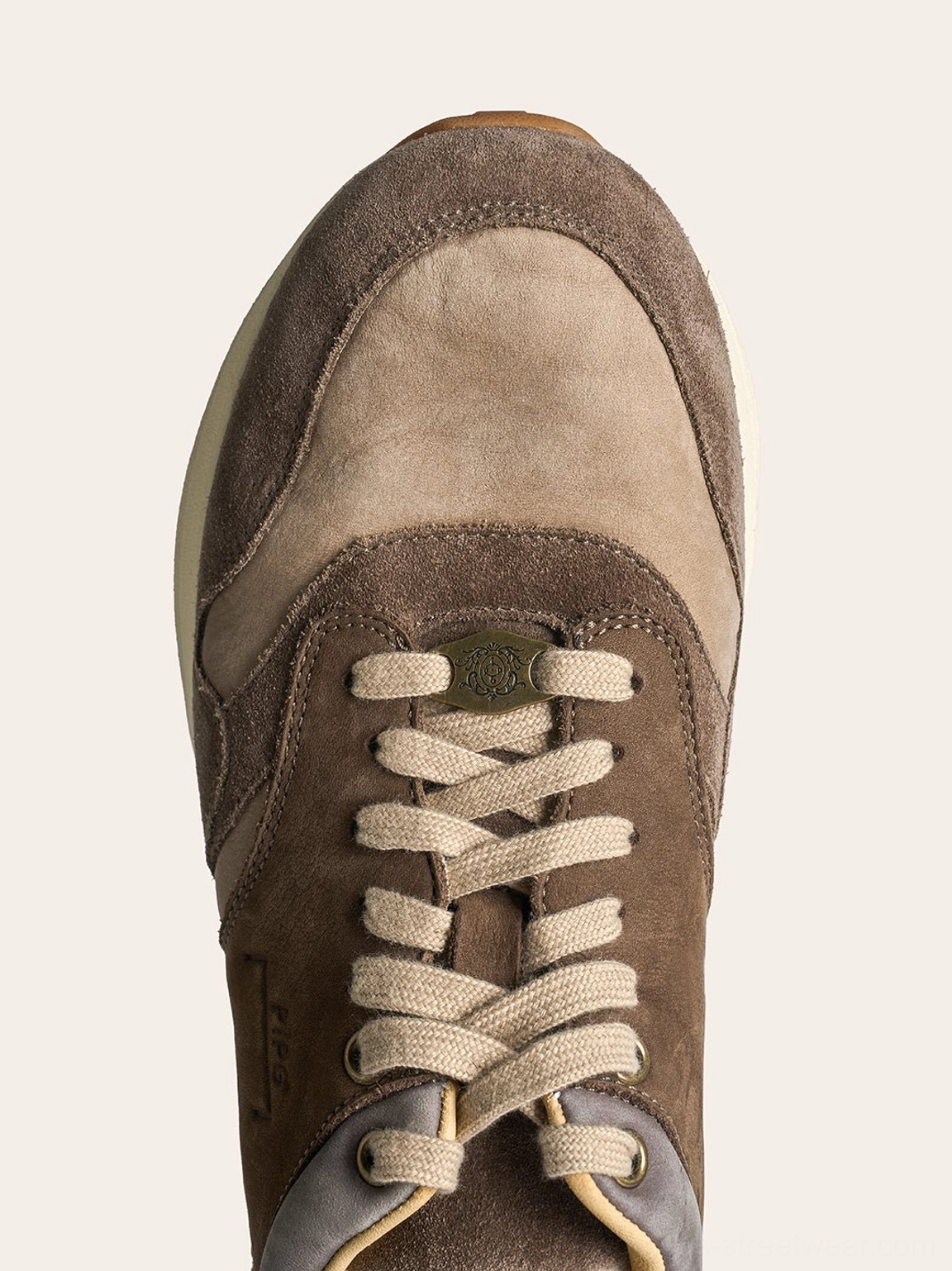 Top view of washed brown trail runner sneaker showing tonal suede panels flat laces and rounded toe