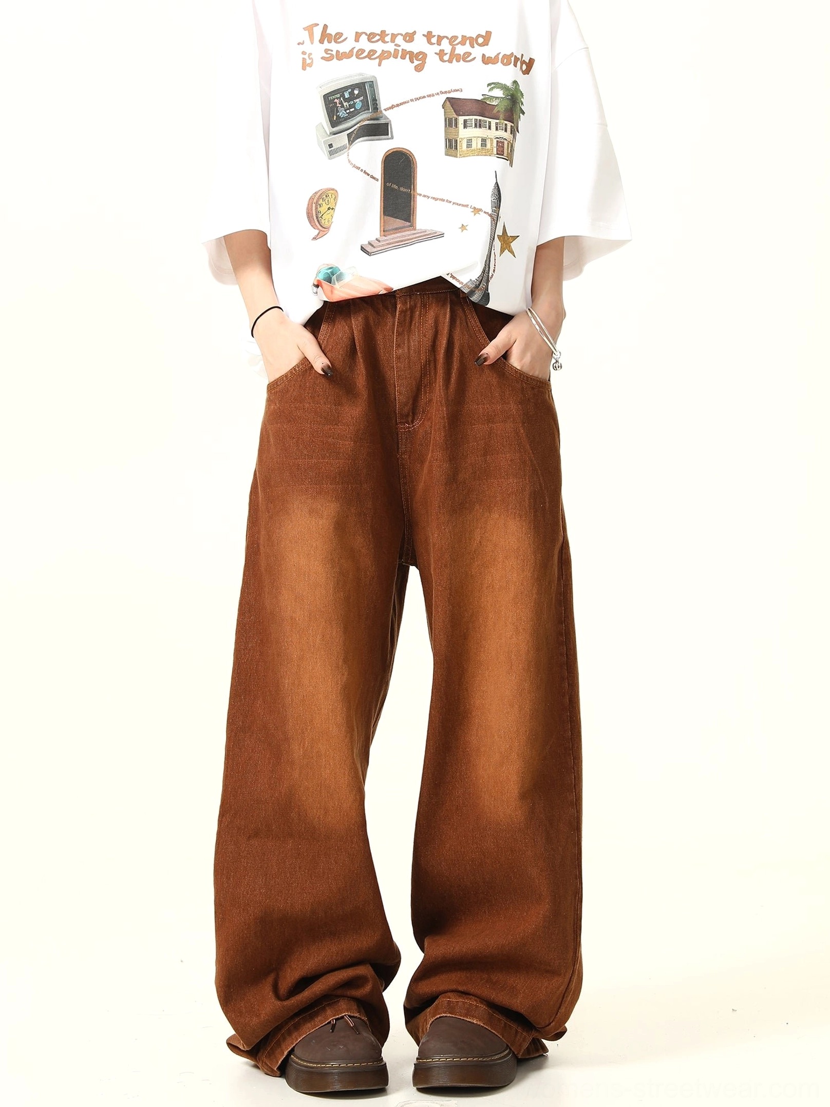 Front view of washed brown vintage wide leg denim pants styled with a graphic T-shirt and casual brown shoes