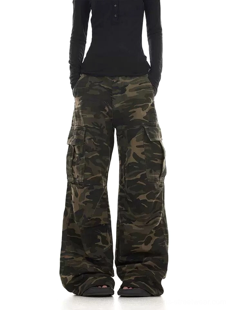 Women’s faded camouflage cargo pants styled with a black long sleeve top in a relaxed wide leg streetwear fit
