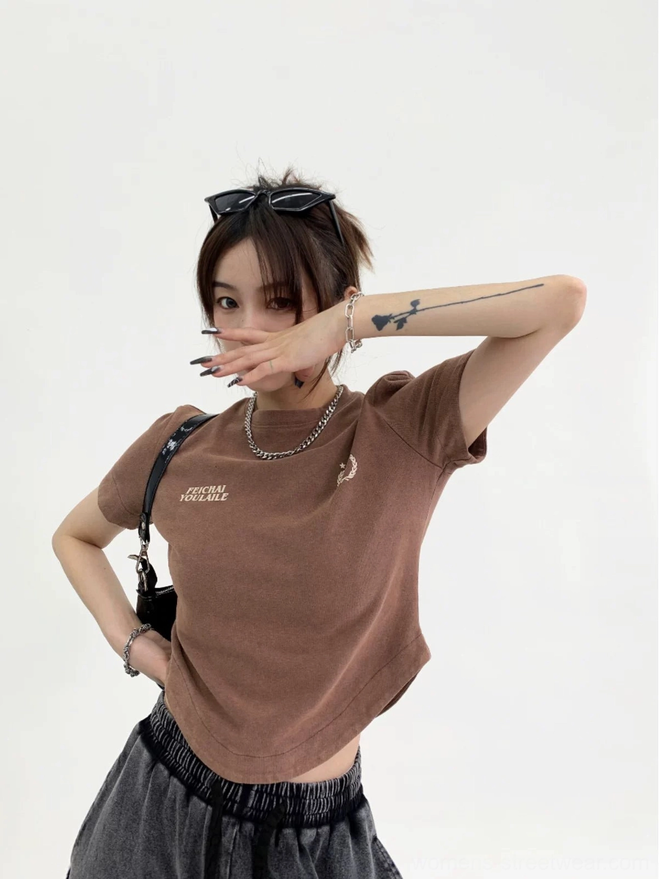Dark brown washed collegiate logo curved hem streetwear t-shirt front three-quarter view