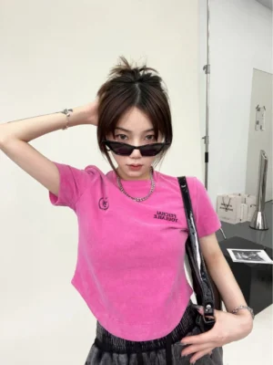 Hot pink washed collegiate logo curved hem streetwear t-shirt front view on female model
