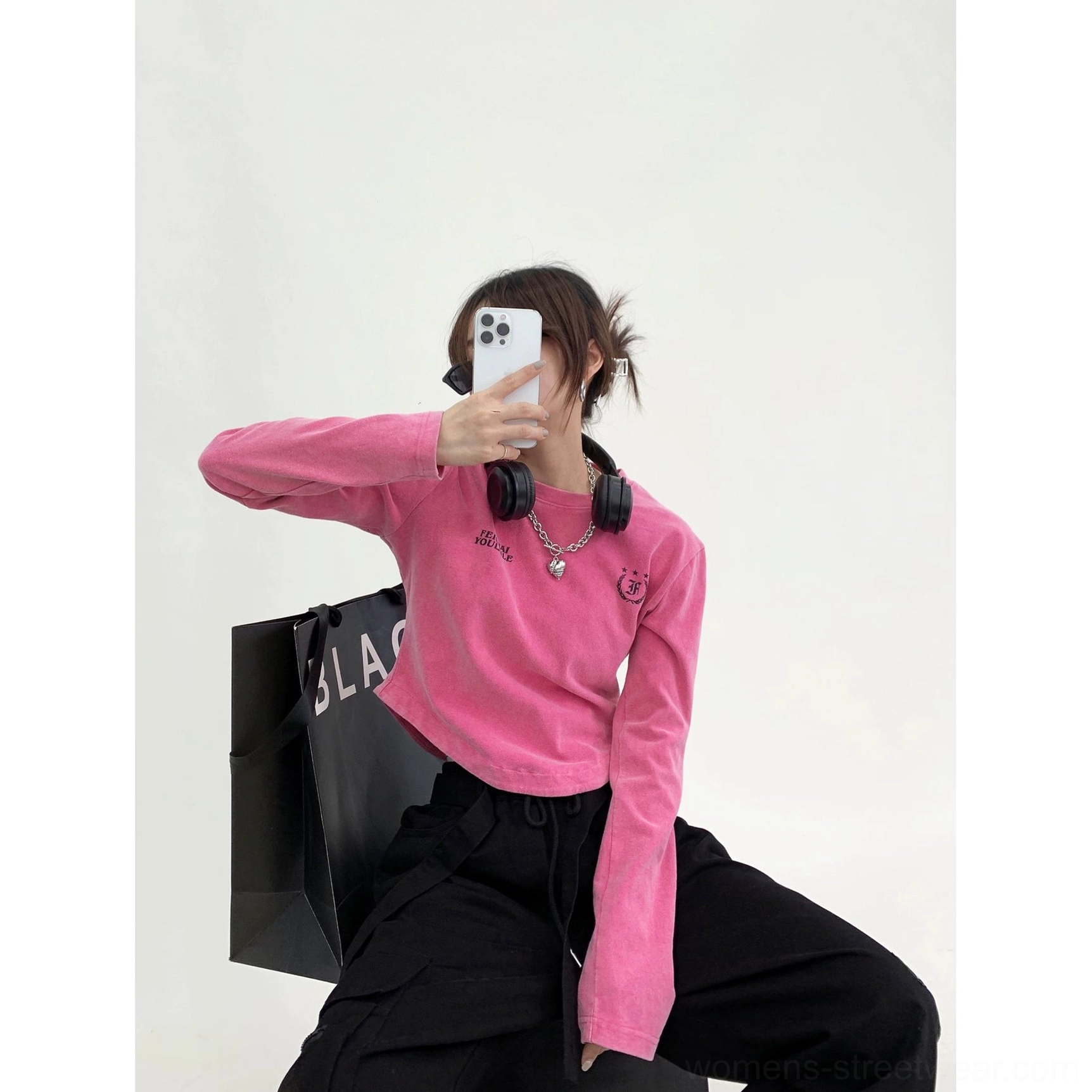 Hot pink washed collegiate logo curved hem streetwear t-shirt low angle mirror selfie styling view