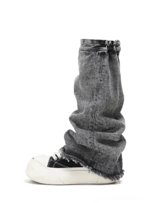 Washed denim-look black platform sneaker with white rubber sole and grey frayed denim leg warmer