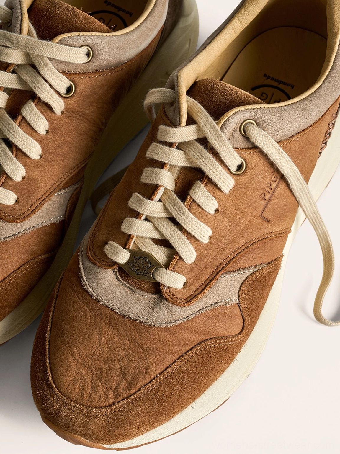 Washed earth tone trail runner sneakers with padded heel and textured lugged outsole for streetwear looks