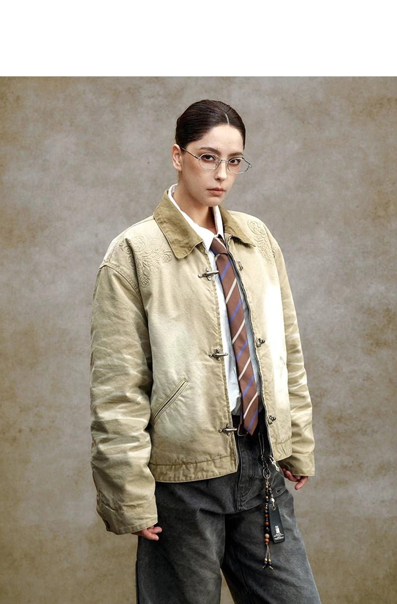 Washed embroidered utility jacket product image with contrast collar, metal toggle closures, and relaxed cropped workwear silhouette