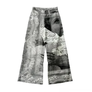 Front flat lay of washed gray convertible wide-leg jeans featuring digital portrait, flying bird, scroll floral prints, mid-rise waist, pockets, and classic denim hardware