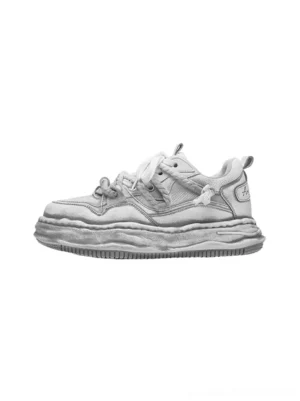 Side view of washed grey wavy platform sneakers showing the distressed vintage finish layered upper thick flat laces and sculpted streetwear sole