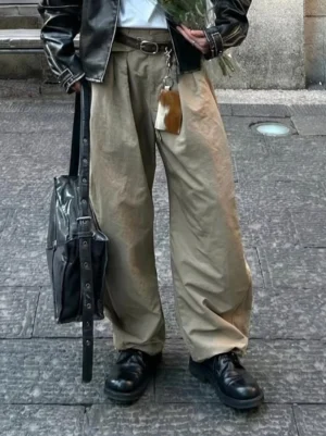 Black washed horsehide round-toe derby shoes styled with khaki wide-leg trousers and black leather jacket streetwear outfit
