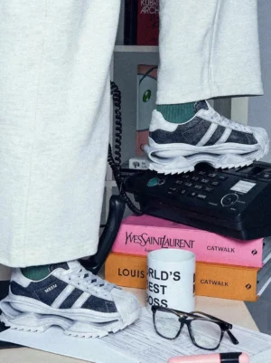 Vintage-inspired washed leather platform court sneakers displayed with retro desktop accessories, showing layered soles and worn-in styling