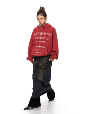 Back view of a washed red oversized hoodie with a classic hooded silhouette, subtle hem lettering, and relaxed Seoul streetwear styling
