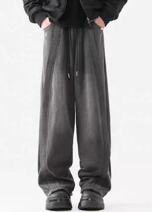 Front view of dark gray washed wide-leg streetwear pants with adjustable drawstring waist and vertical seam detailing