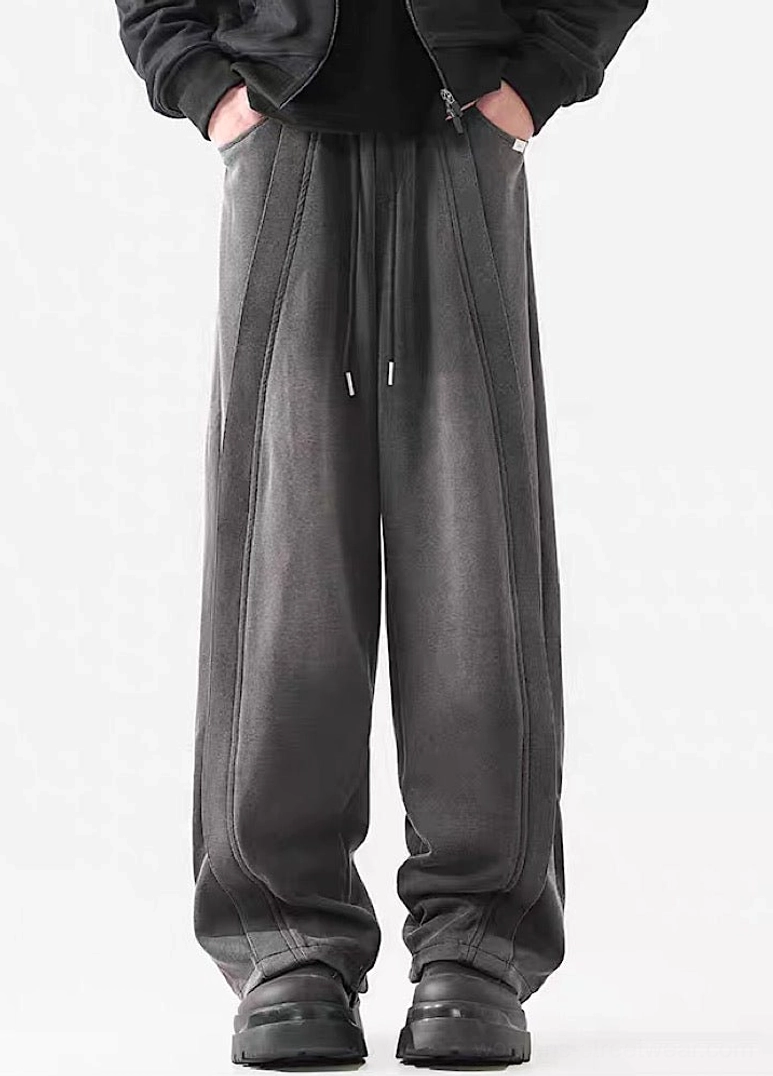 Front view of dark gray washed wide-leg streetwear pants with adjustable drawstring waist and vertical seam detailing