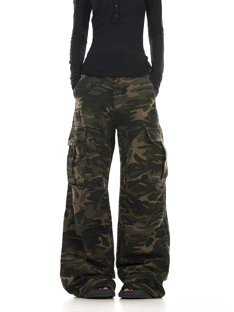 Front view of women’s washed woodland camo wide leg streetwear cargo pants with large utility side pockets