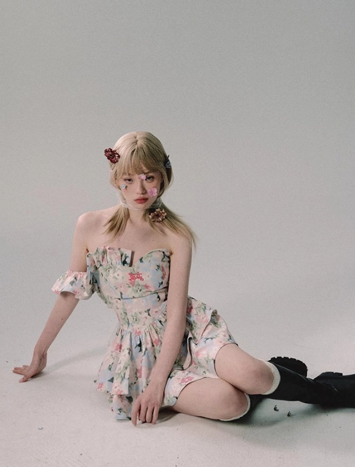 Watercolor floral off-shoulder ruffle mini dress styled as a feminine Seoul streetwear outfit with fitted bodice and flared layered skirt