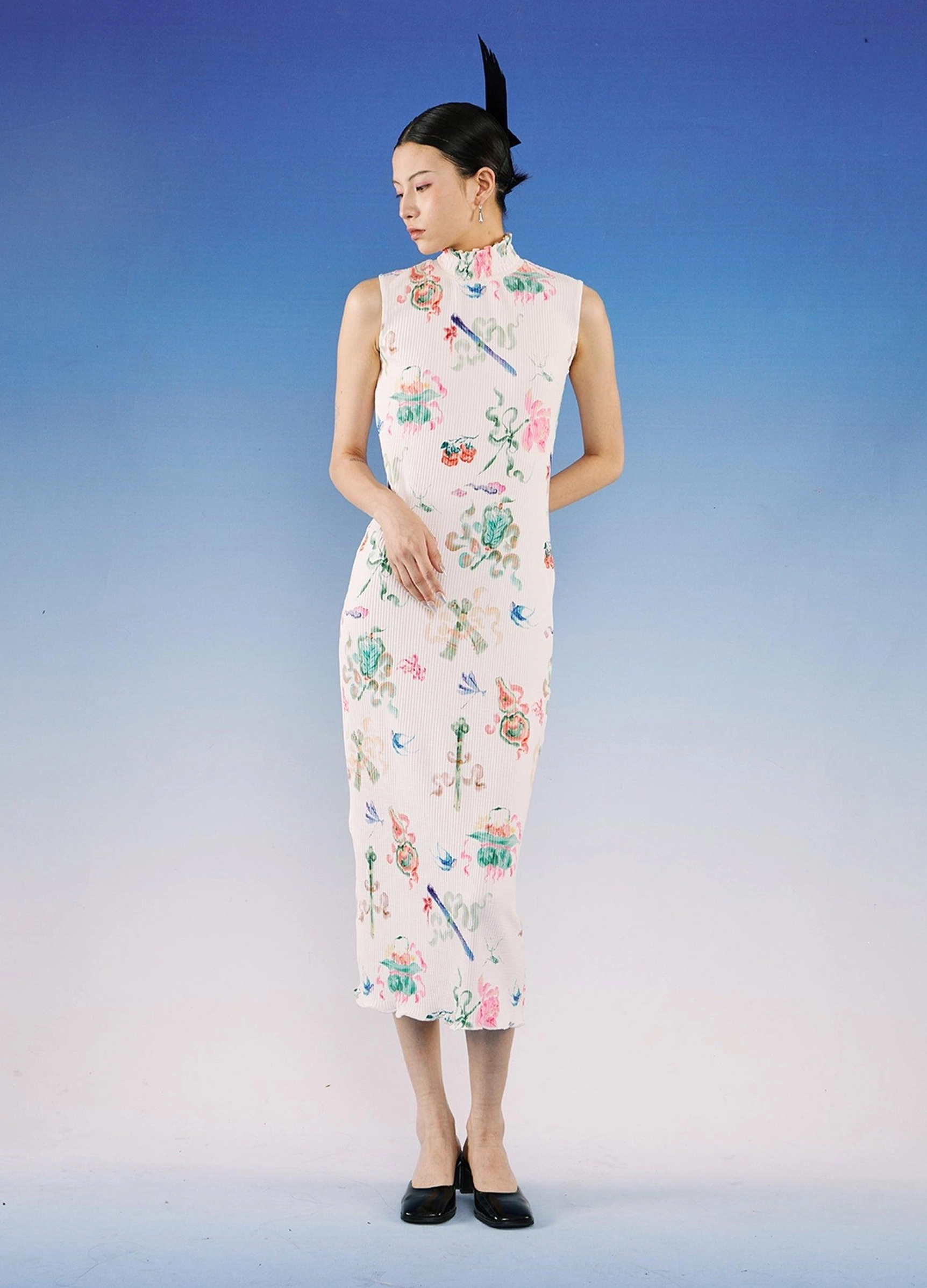 Sleeveless watercolor floral qipao midi dress shown from a side front angle with stand collar, ribbed white fabric, fitted silhouette, and black low-heeled mules