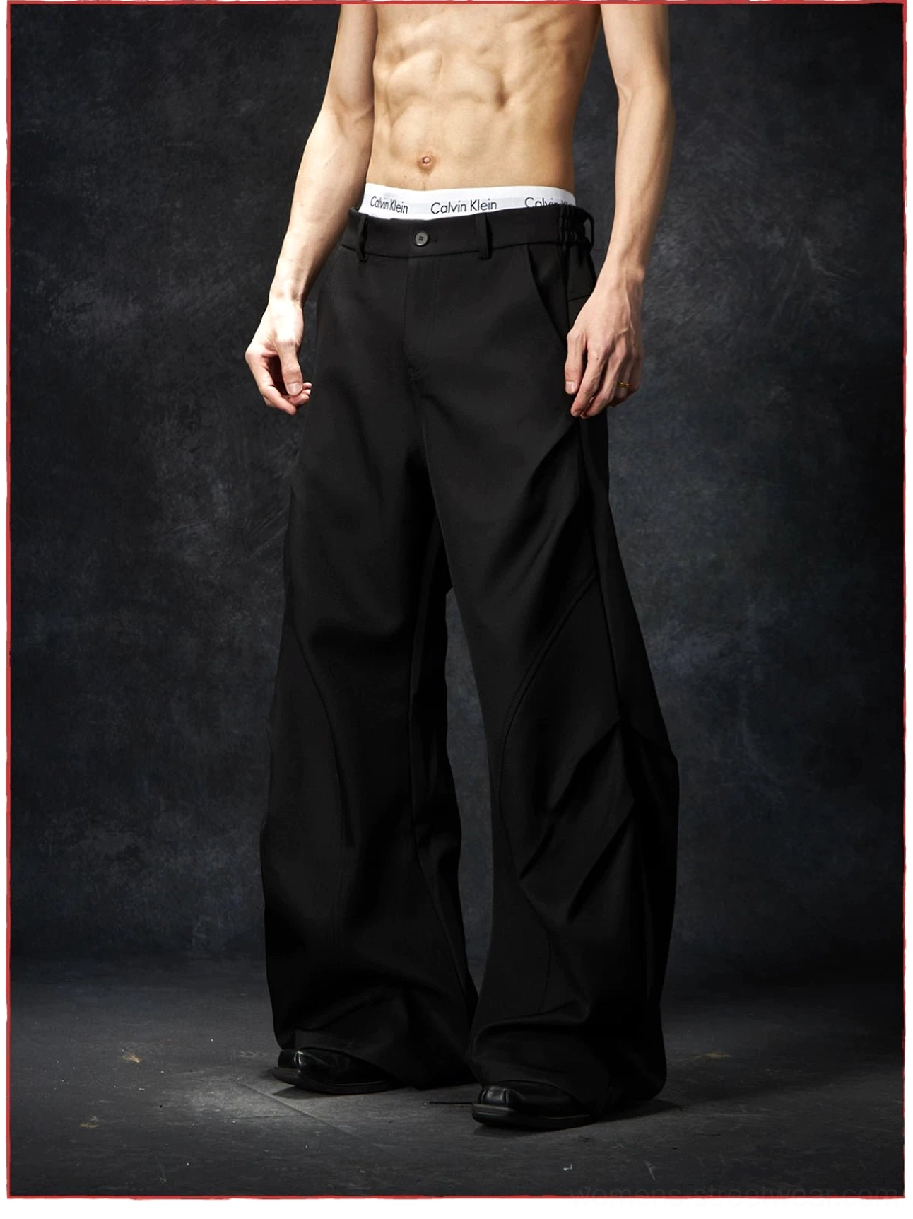 Wave contour wide-leg trousers fashion image featuring contemporary streetwear proportions and architectural curved seam detailing