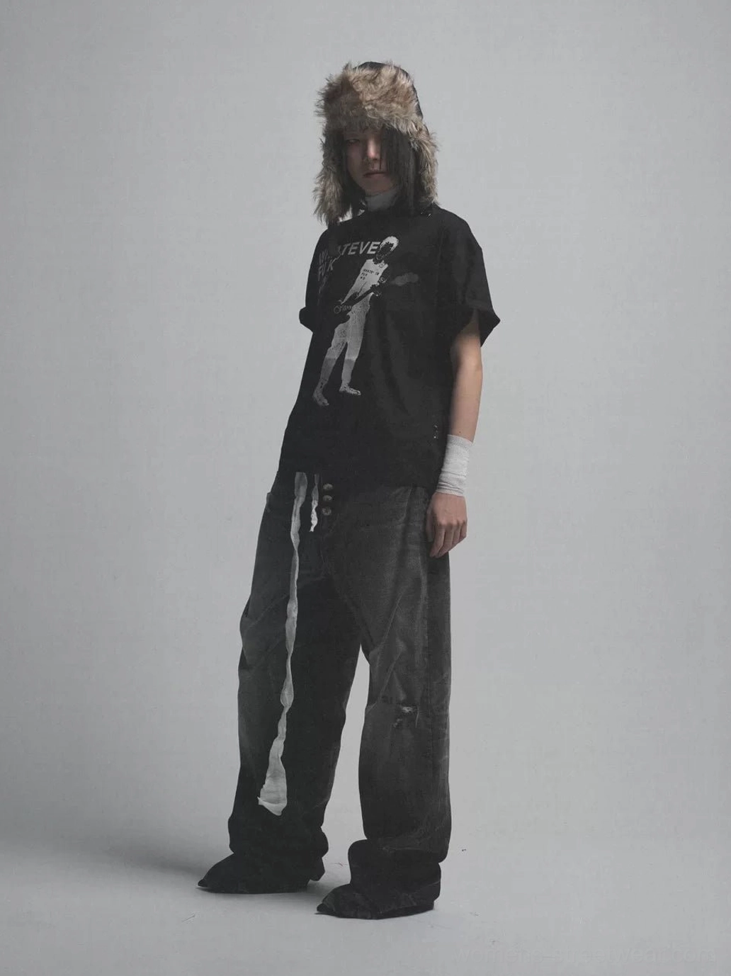 Black oversized guitarist graphic tee with punk photo print styled with vintage wide leg jeans