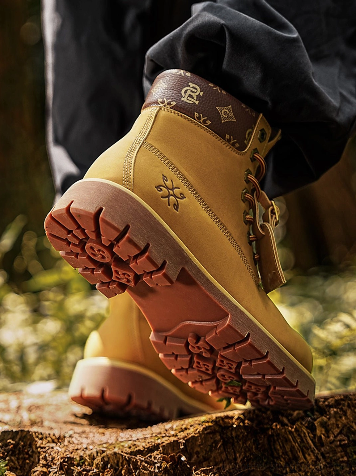 Heel and outsole detail of wheat contrast-stitch lug sole work boots with padded patterned brown collar
