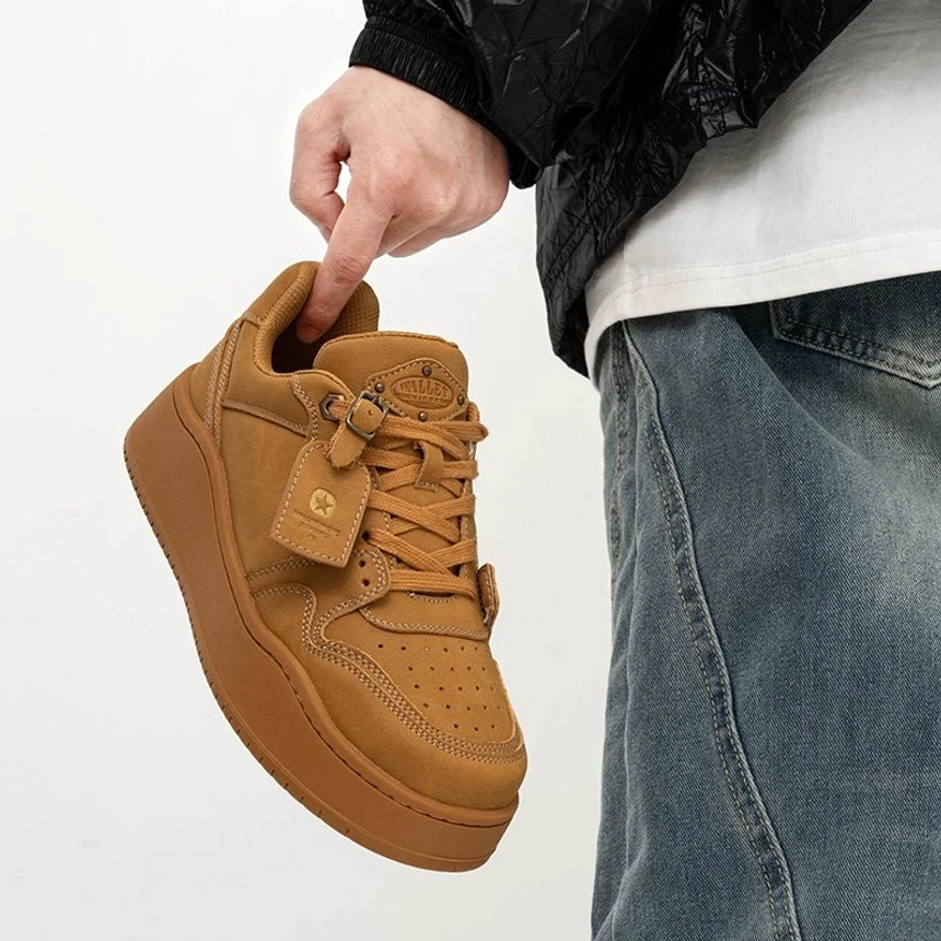 Angled close-up of wheat yellow nubuck platform skate sneaker showing soft textured upper, lace-up design and thick tonal sole