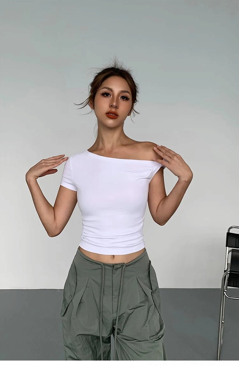 Model adjusting a white asymmetric off-shoulder crop tee with a slim fitted silhouette and army green cargo pants