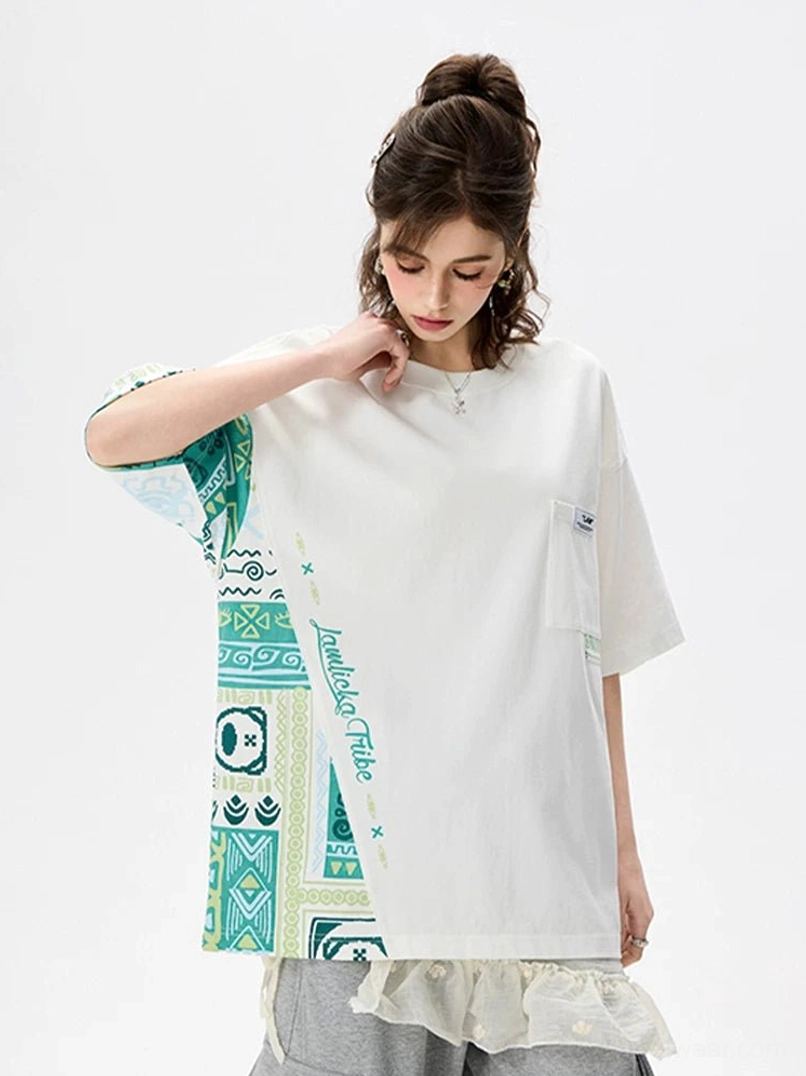 White asymmetric tribal panel oversized heavyweight cotton T-shirt front view on female model with green patterned sleeve and side insert