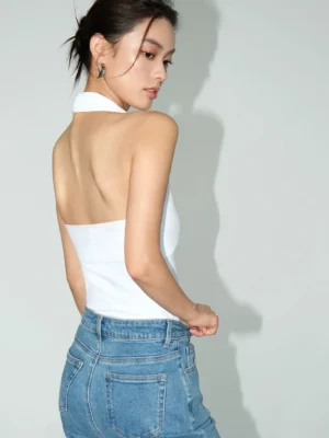 White backless halter knit top shown from the rear with an open back and slim fitted silhouette