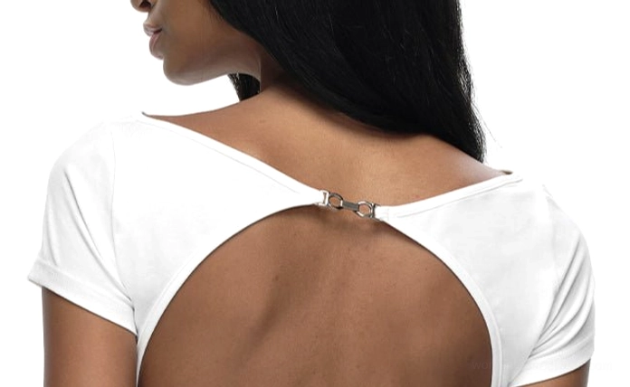 White backless streetwear T-shirt showing the large open-back cutout and metallic upper-back button detail
