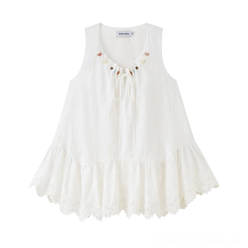 Flat lay of white beaded eyelet lace tunic top with round drawstring neckline, flared silhouette, and scalloped hem