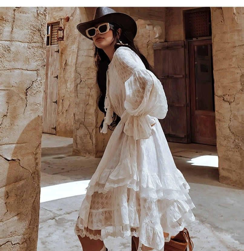 White boho ruffle midi dress with voluminous long sleeves layered hem and effortless western streetwear styling