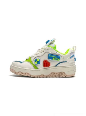 White building block chunky platform skate sneakers shown from the side on a clean studio background with colorful green blue and red patches and a thick textured rubber outsole