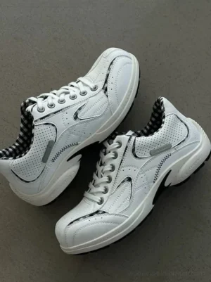 Pair of white checkered collar retro runner sneakers viewed from above with black plaid lining, lace-up closure, and breathable perforated side panels