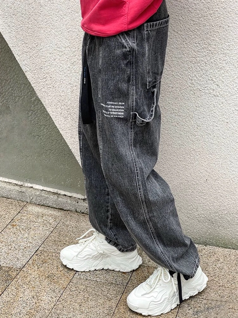 White chunky lava wave sneakers paired with dark cargo jeans and a red cropped top for futuristic casual streetwear