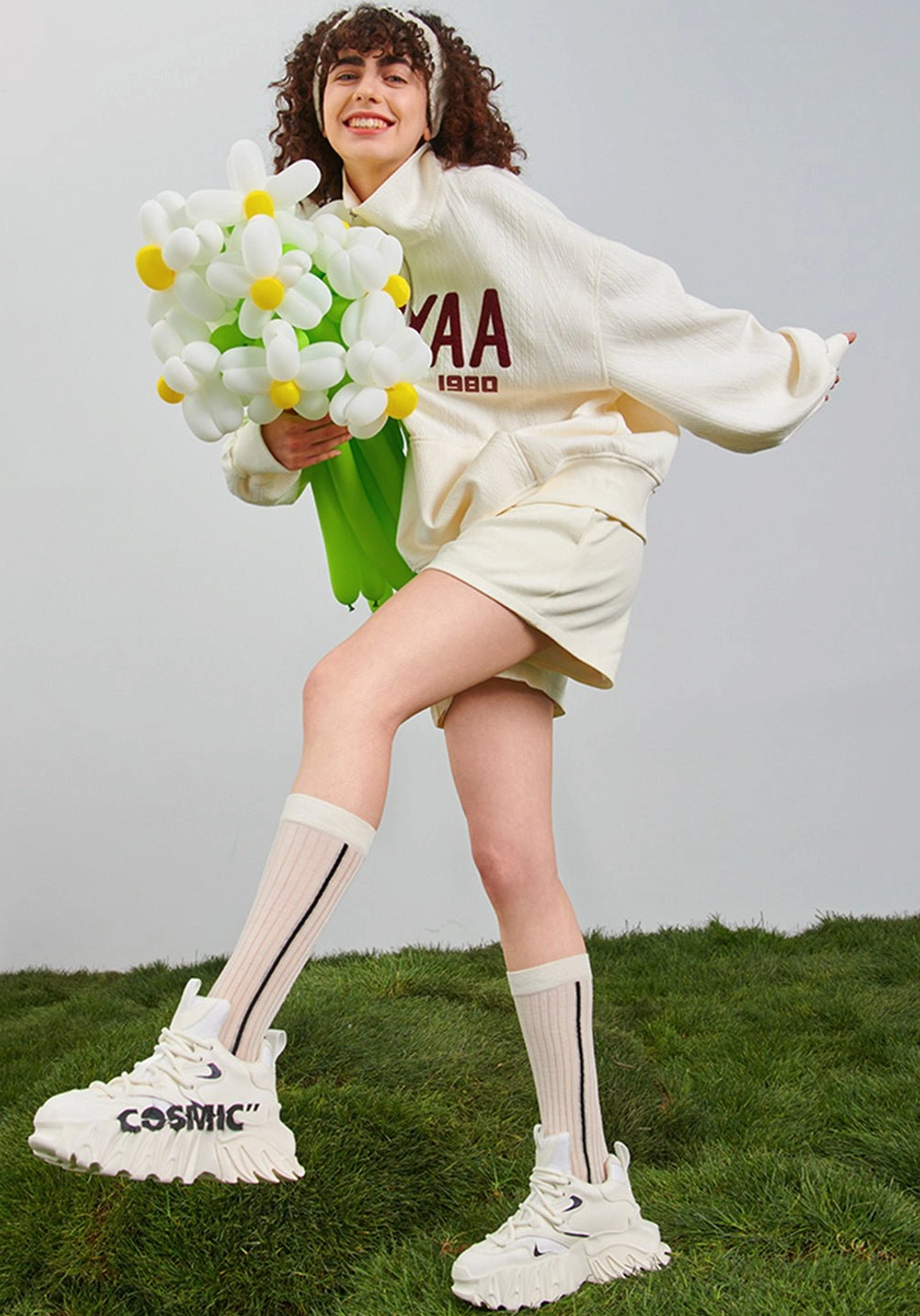 White chunky platform derby shoes styled with cream streetwear and sculpted white outsole outdoors