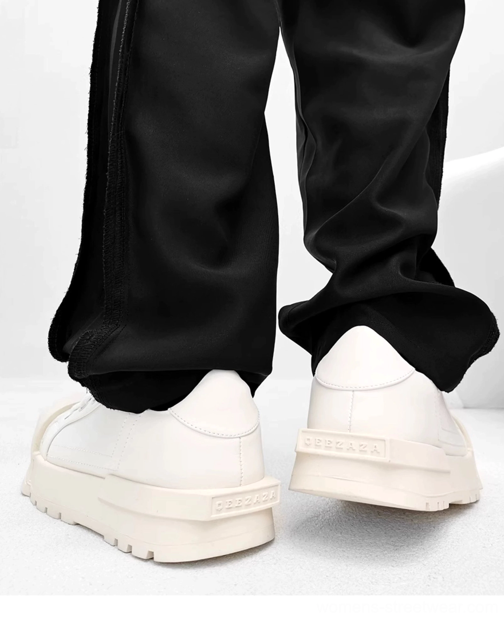 White chunky platform sneakers rear low angle view showing clean heel detail and thick elevated outsole
