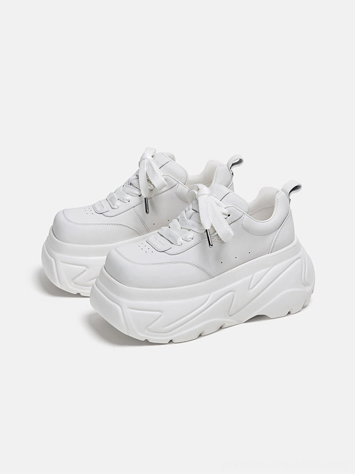 White chunky platform sneakers shown from the front side with sculpted outsole, lace-up closure, and rear heel pull tabs