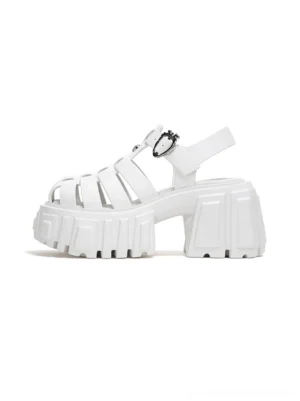 White chunky Roman platform sandals with caged fisherman-style upper, heart-shaped ankle buckles, and thick lugged soles on a white background