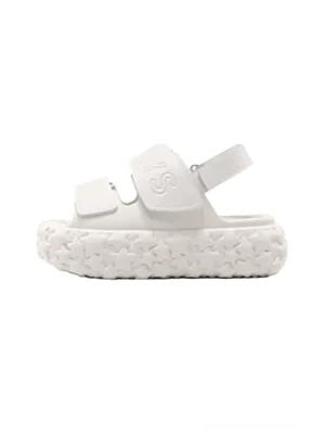 White chunky star platform sandal shown in left side profile with matte off-white finish, embossed strap lettering, thick textured star outsole, and adjustable ankle fastening