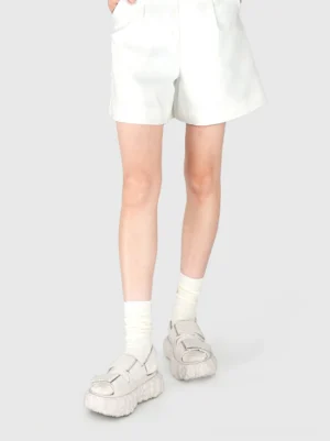 Model wearing white chunky star platform sandals with white crew socks and matching shorts in a clean Korean streetwear inspired outfit