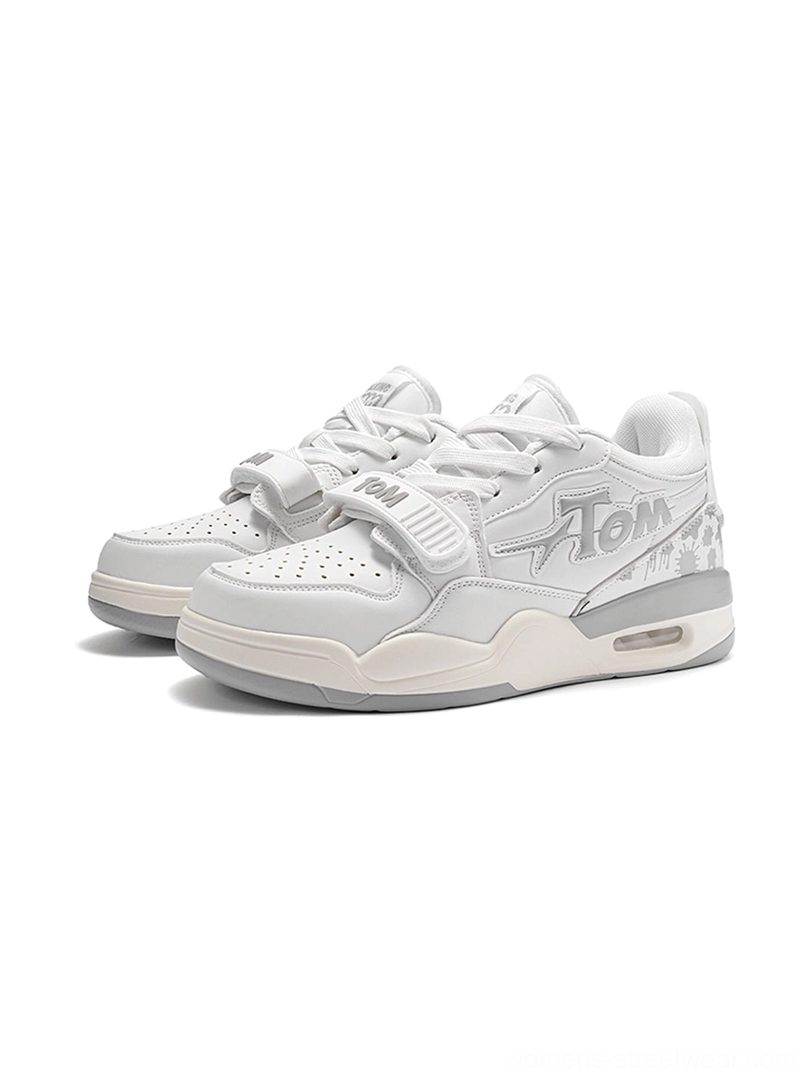 Pair of white colorblock basketball-inspired court sneakers with dual strap details, graphic side panels, patterned accents, and cushioned sole
