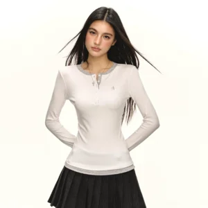 White contrast trim Henley slim long sleeve top paired with a black pleated mini skirt