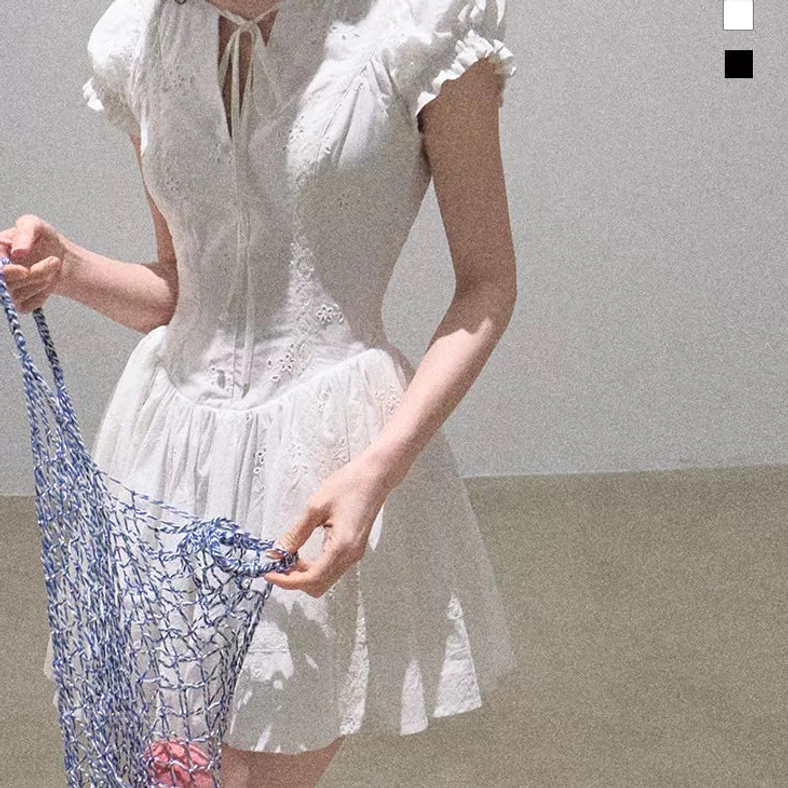Gardenia white cotton eyelet flutter sleeve mini dress with fitted waist and A-line skirt