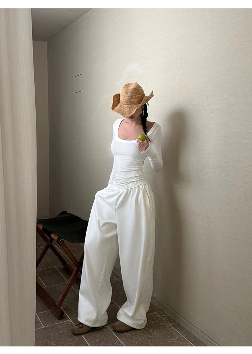 White cotton wide-leg streetwear pants product image showing the clean monochrome finish and flowing relaxed silhouette
