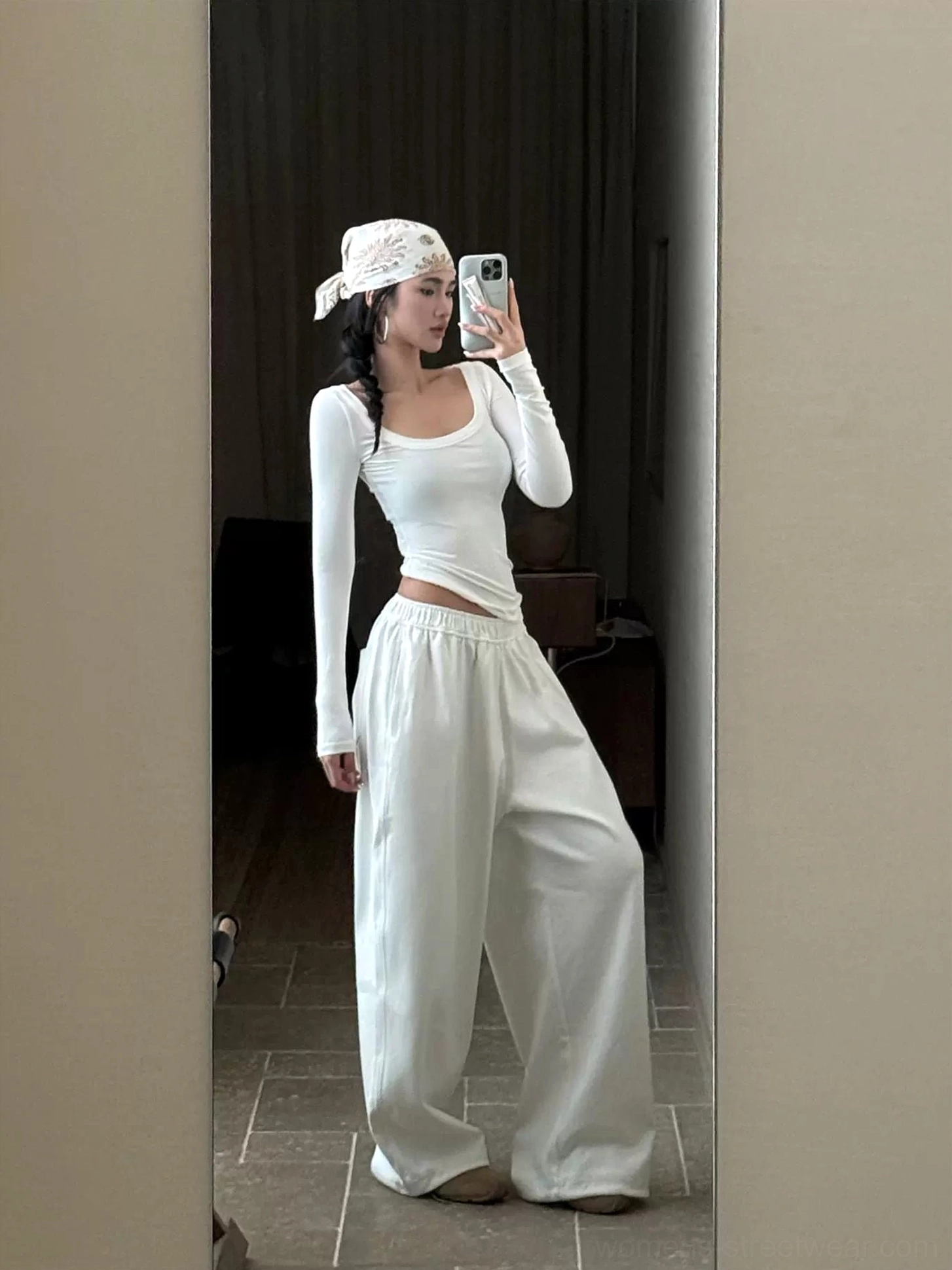 White cotton wide-leg streetwear pants with soft drape styling and a fitted top featuring a waist cutout